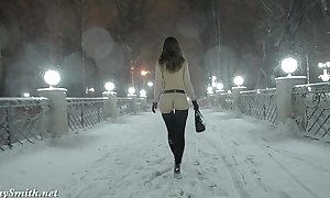 Jeny smith in nature's garb in snow fall walking through the city